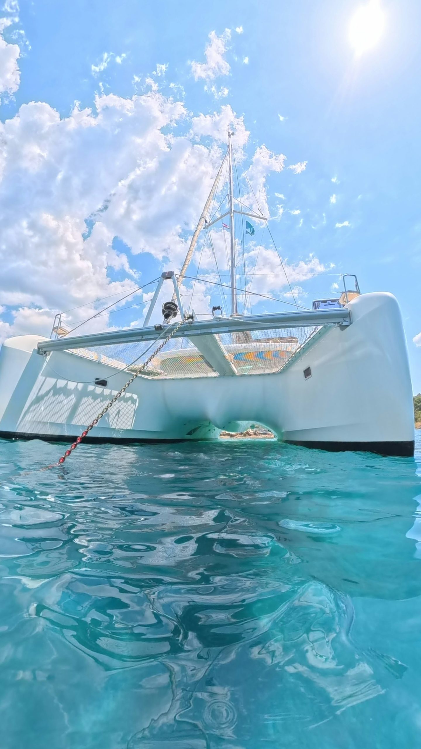 White catamaran in turquoise water, a tour operator weighing FareHarbor alternatives