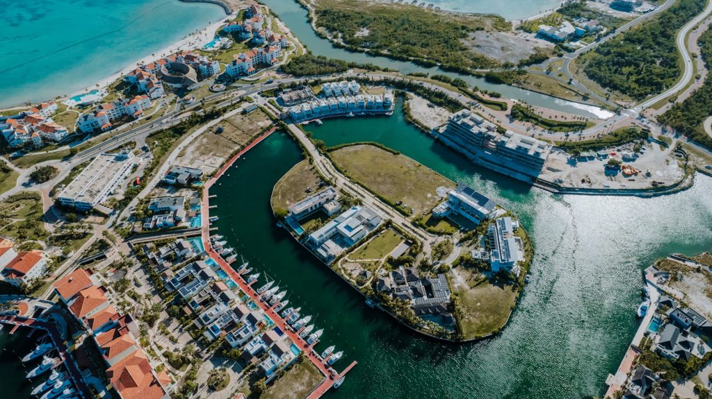 Aerial view of an island resort with white sand beach and turquoise water