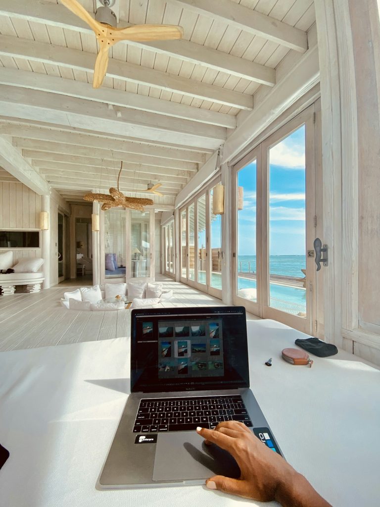 Laptop on a clean white table, hotel website design