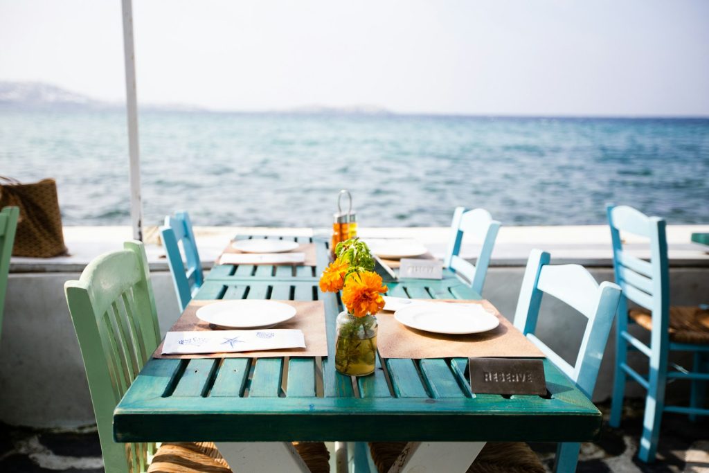 Dining tables set by the sea at an island restaurant