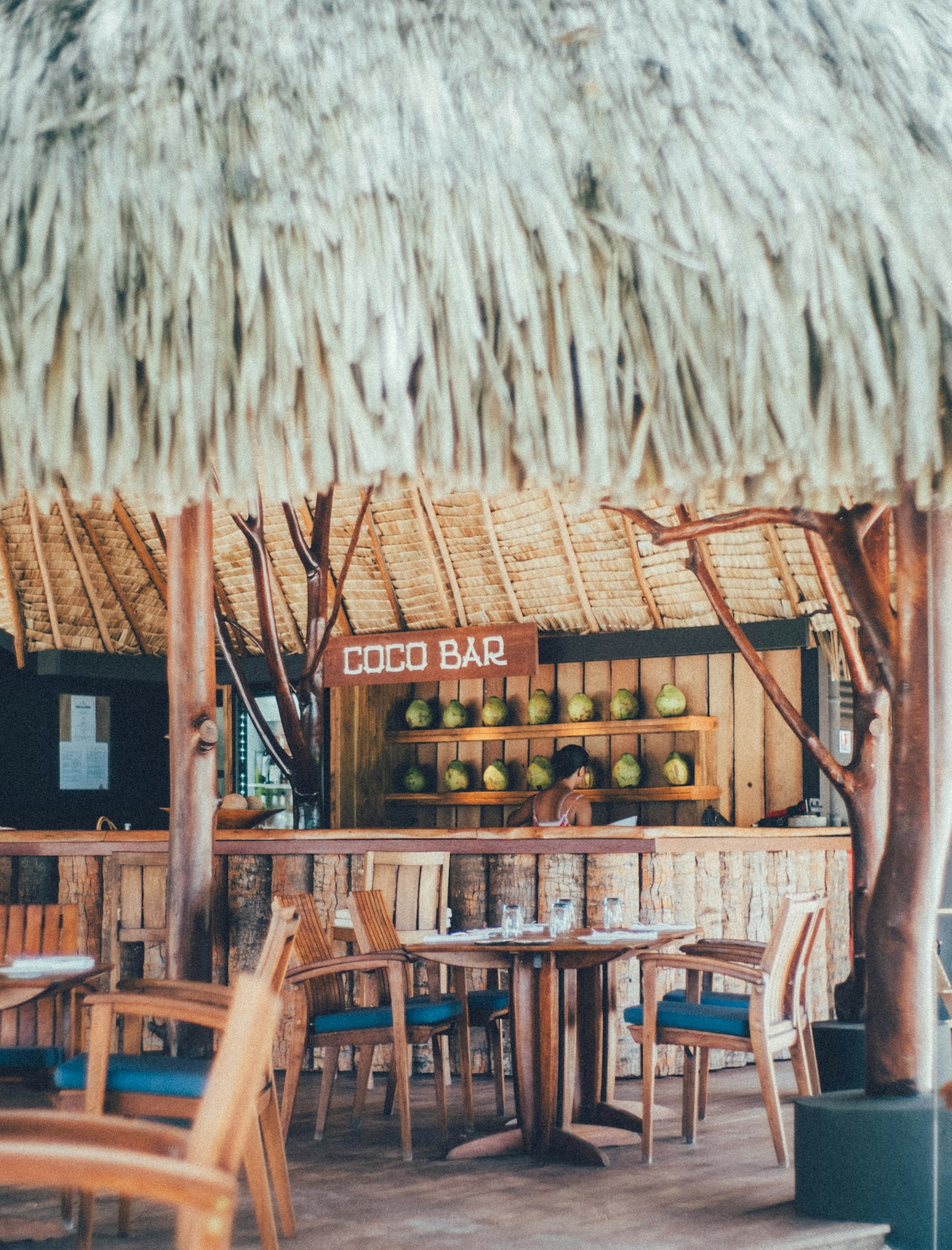 Empty thatched-roof restaurant tables from restaurant no shows