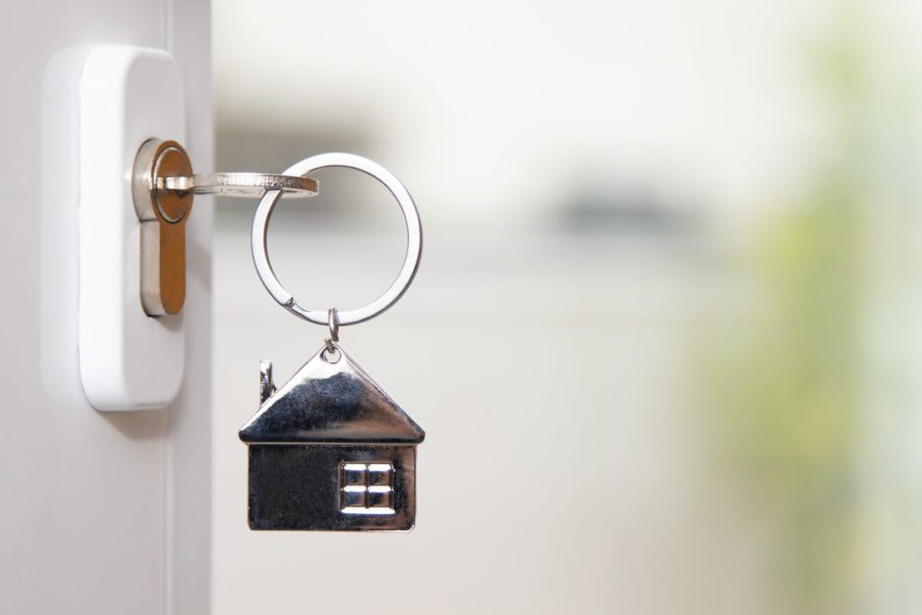 Best Airbnb management companies: house key in the door of a rental property