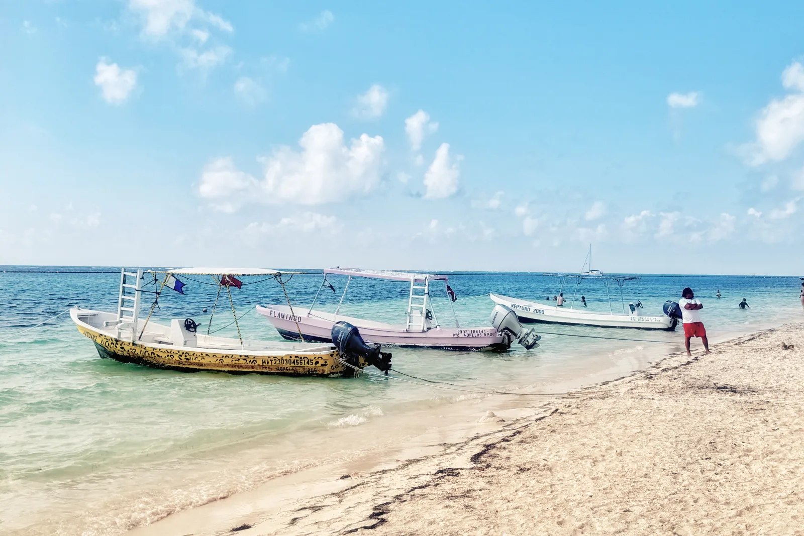 Small fishing boats pulled up on the sand at Puerto Morelos, Quintana Roo