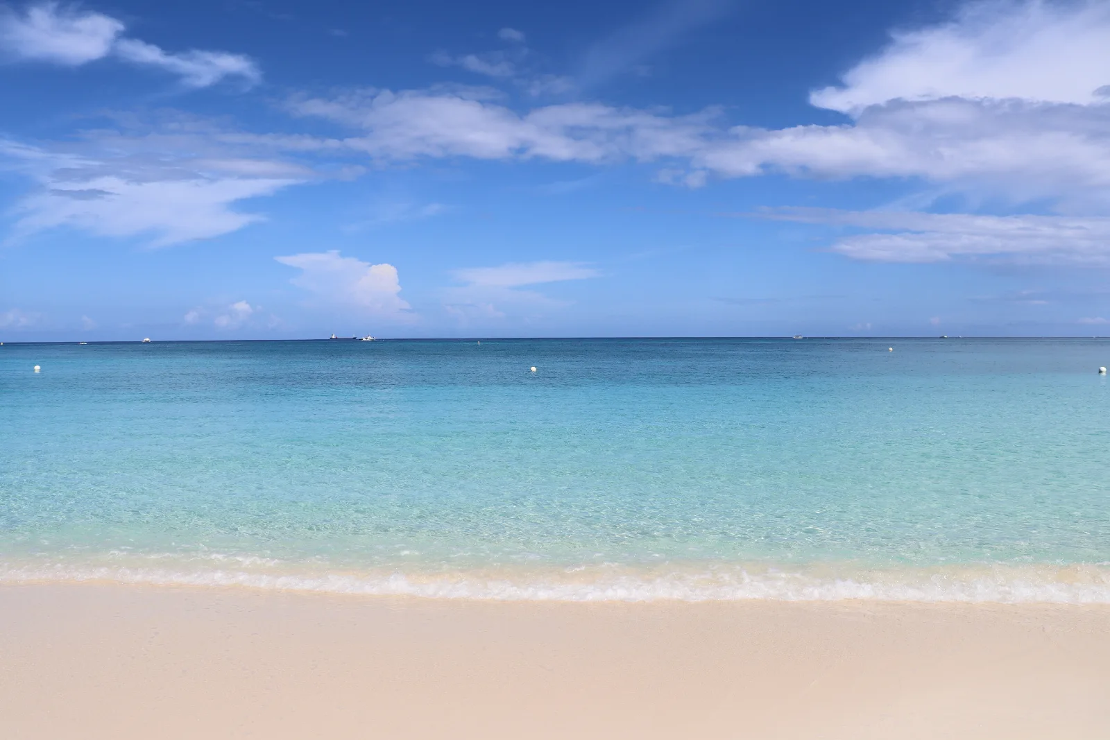 Seven Mile Beach on the west coast of Grand Cayman, calm turquoise water meeting white sand