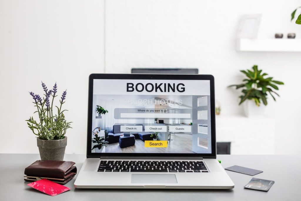 hotel booking engine comparison shown on a laptop screen with a credit card
