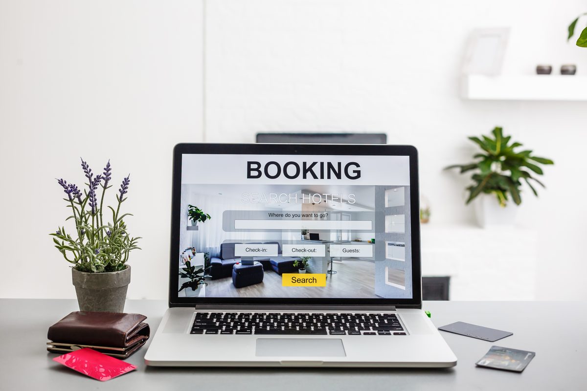 hotel booking engine comparison shown on a laptop screen with a credit card