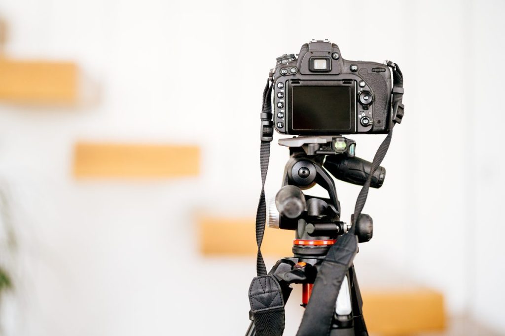 How to make your vacation rental stand out: camera on a tripod shooting a styled interior for a listing photo