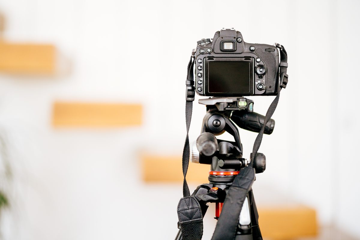 How to make your vacation rental stand out: camera on a tripod shooting a styled interior for a listing photo
