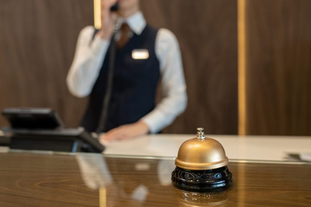 Small hotel front desk where a free hotel channel manager keeps OTA calendars in sync