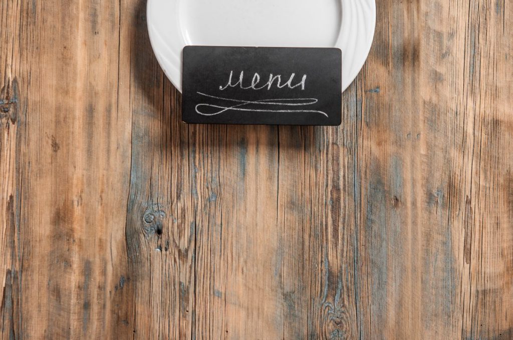 menu pricing strategy chalkboard menu card on a wood table