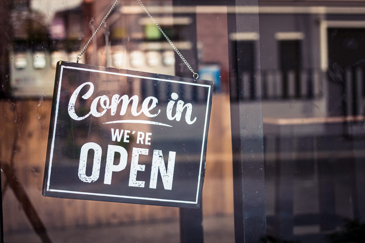 Restaurant marketing basics: an open sign hanging in a restaurant window