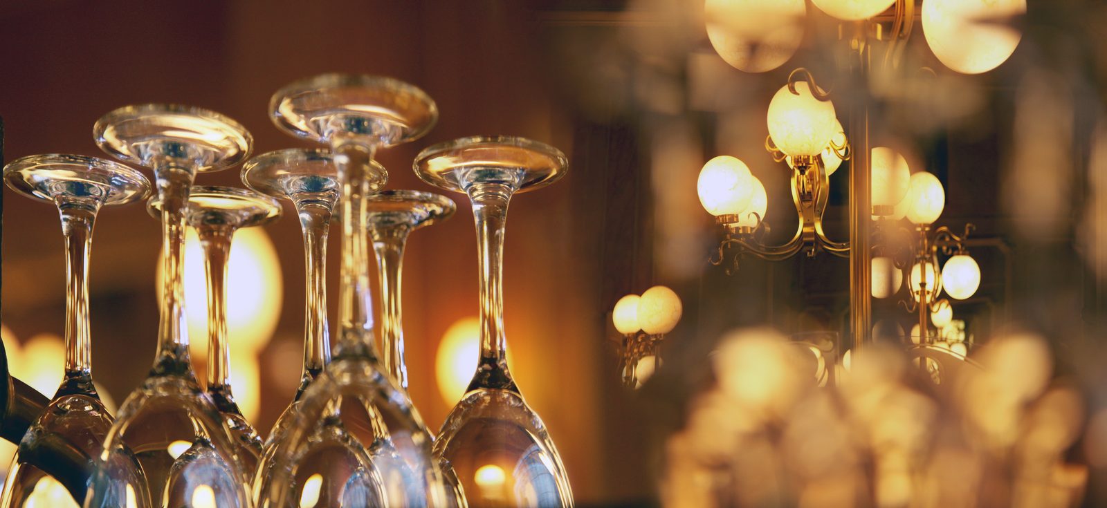 Restaurant marketing: a warm restaurant bar with glassware and low golden light