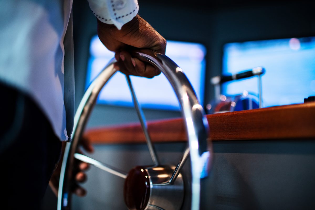 Yacht charter marketing: a charter captain at the boat controls, running the trip he booked direct