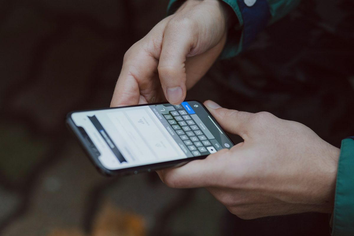 AI chatbot for hotels: a guest typing a question on a smartphone