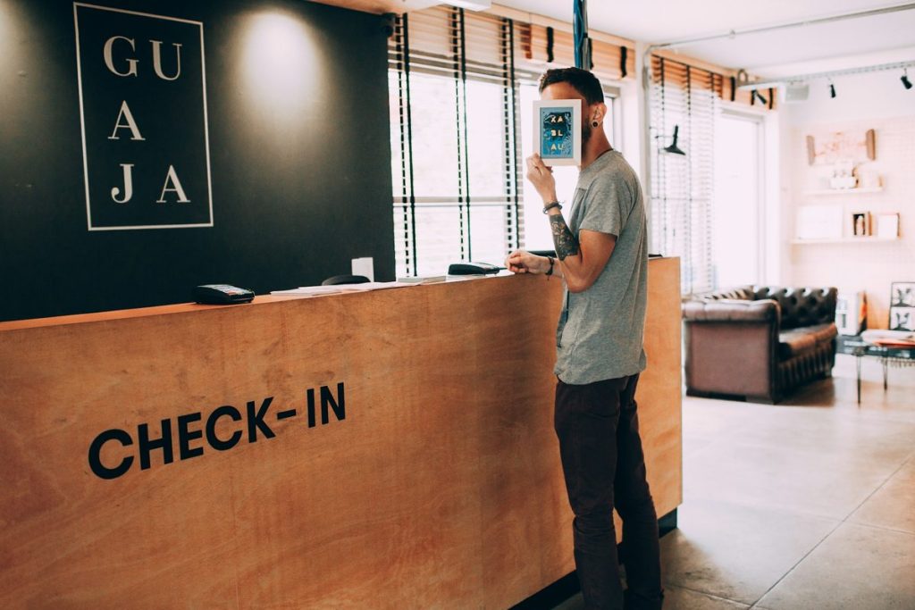 AI in hospitality industry: hotel check-in desk with a staff member at the counter