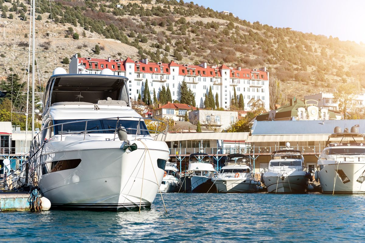how to start a boat rental business rental fleet of motorboats moored at a harbor dock