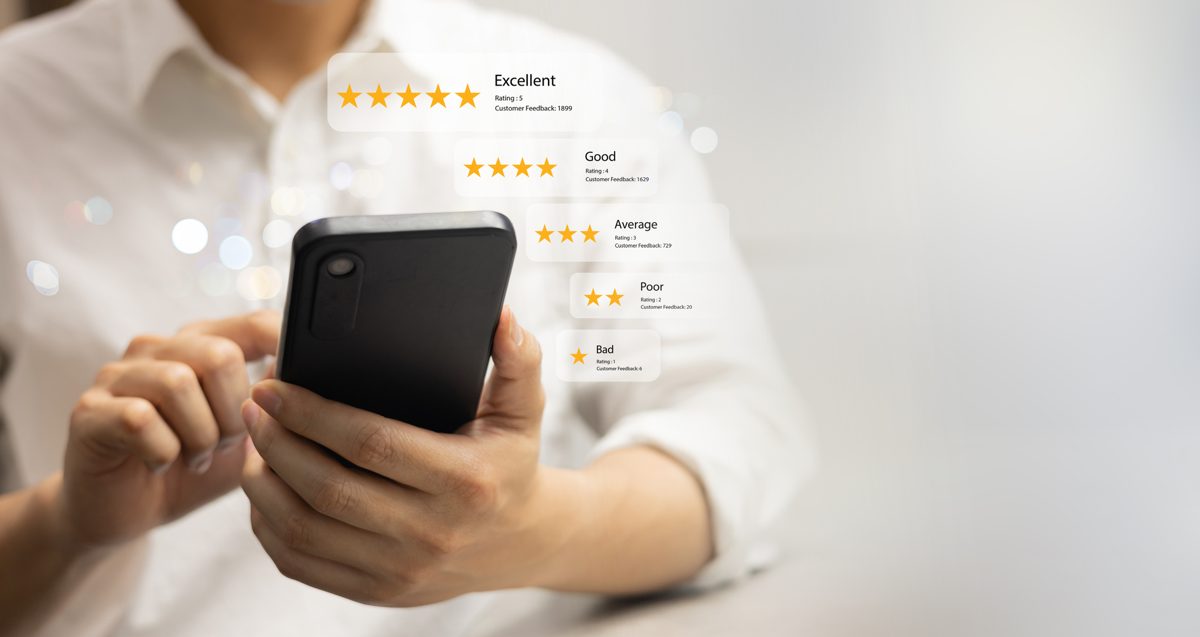 A traveler reading reviews on a phone, why how to get more Tripadvisor reviews matters