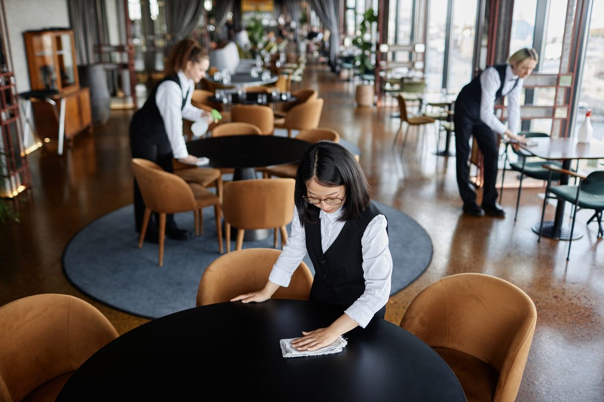 Staff resetting tables before service, part of how to save a failing restaurant
