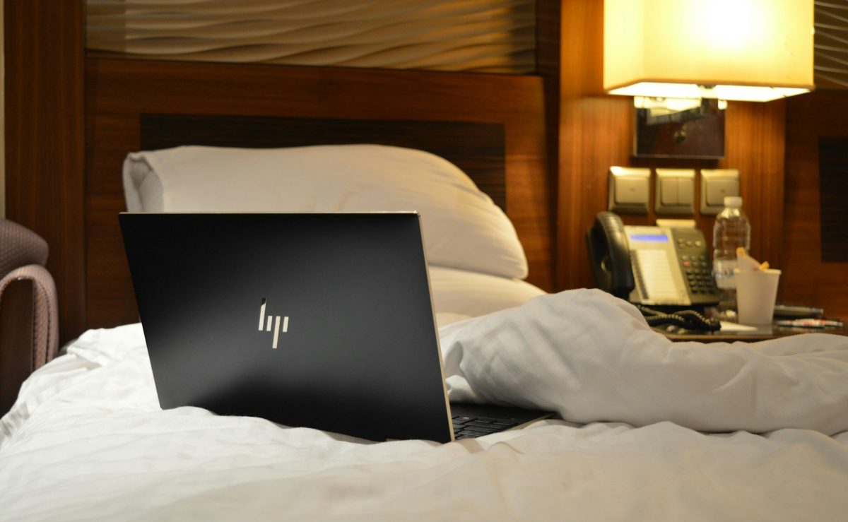 Cómo aparecer en ChatGPT: una laptop abierta sobre la cama de un hotel