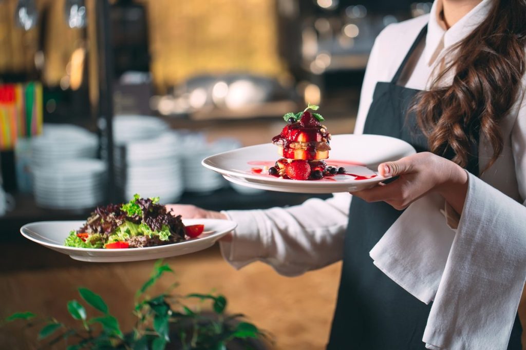 Restaurant labor cost percentage: a server moving fast through a busy dining room