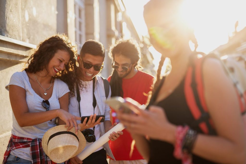 Viator vs GetYourGuide: travelers comparing tours on a phone